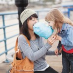 Mom and Daughter Taking a Bite Out of Cotton Candy